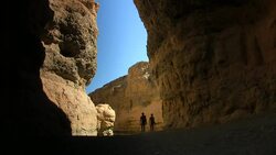 bushmen walking in canyon Stock Footage