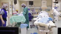 Surgeon and nurse working with surgical instruments in operation room Stock Footage