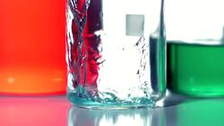 Blue liquid pouring into beaker Stock Footage