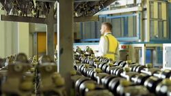 Workers talking behind printing press machinery Stock Footage