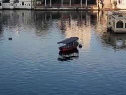 Small boat on Lake Pichola, India Stock Footage