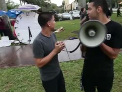Mid Shot of protesters with loudspeakers chanting Immigration Activists Protest Outside Of Marco Rubio Fundraiser at Biltmore Hotel on April 05, 2013 in Miami, Florida (Footage by Getty Images)Immigration Activists Protest Outside Of Marco Rubio Fundraiser Stock Footage