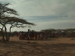 Maasai Ceremony - Warriors jumping up and down, dancing, wide shot group, WITH AUDIO Stock Footage