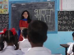 Teacher teaching her school students in a classroom   Stock Footage
