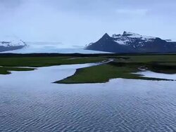 WS PAN View of Fjallsjokull Glacier and choppy lagoon with snow mountain / Iceland Stock Footage