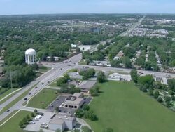 Suburban intersection with light traffic and water tower Stock Footage