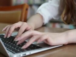 unrecognizable female student using laptop in library,real time. Stock Footage