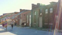 MS TD PAN Women running together on urban street at sunrise Stock Footage