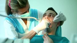 Young man under dental procedure. Stock Footage