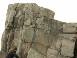 Buisness man climbs mountain Stock Footage