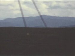 Amateur Vietnam Marine Footage panning across distant mountains. Close-up of smiling soldier in hat, sunglasses and t-shirt. Stock Footage