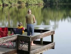  WS TU Mother and daughter fishing on dock / St. Simon's Island, Georgia, USA Stock Footage