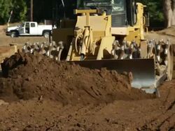 Bulldozer Moving Earth Towards Viewer Stock Footage