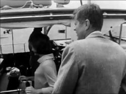 B/W 1961 REAR VIEW John + Jacqueline Kennedy getting on boat at dock / Hyannis Port Stock Footage