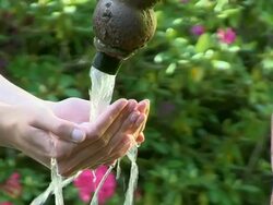 CU Young womans hand drinking water from well / Saarburg, Rhineland-Palatinate, Germany Stock Footage