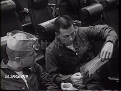 1965: USS ENTERPRISE: OPERATION MAIL BAG: Lt. Charlie Baldock listening to unidentified pilot SOT reading letter from lady in Pennsylvania. HA WS Front carrier deck w/ parked A-4 'Skyhawk' jets, choppy sea beyond. Instructional Video