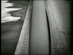 B/W 1940's close up tilt up of swaying bridge cable / Galloping Gertie / Tacoma Narrows Bridge / SOUND Stock Footage