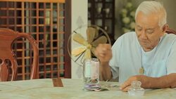 senior man counting money with glass bank Stock Footage