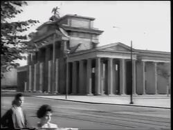 B/W 1961 PAN from Brandenburg Gate to soldiers digging ditch / construction of Berlin Wall Stock Footage