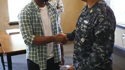 Military recruiter talking with young African American man Stock Footage