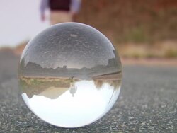 MS CU Crystal ball with inverted man walking on asphalt road/ Tucson, Arizona, United States Stock Footage