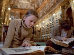 Medium shot girl and boy reading books in Philosophical Hall library at Strahov Monastery / Prague Stock Footage