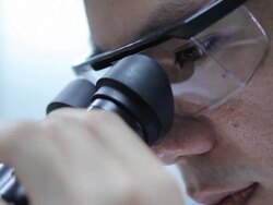Scientist is using with microscope Stock Footage