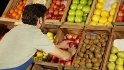 Man organizing fruist in a greengrocery Stock Footage