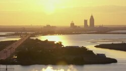 Sunset with view of Mobile, Alabama skyline and surrounding bay areas. Stock Footage