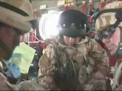 British Medical Emergency Response Team treat a wounded soldier on board a helicopter Stock Footage