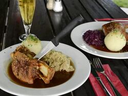 MS Roast duck and roast pork with dumpling and pickled cabbage on dinner table / Mainburg, Bavaria, Germany Stock Footage