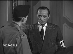 1944: DRAMATIZATION: RESISTANCE MALE: WS Building windows w/ many flags. 'Resistance' male turned leader saying they want to catch Germans, must be killed, or will return. French will take pleasure in occupying Germany. Instructional Video