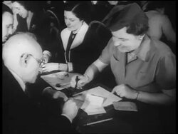B/W 1940s woman + man seated at table looking at ration cards / World War II / newsreel Stock Footage