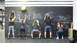 Athletes exercising with medicine balls at gym Stock Footage