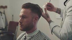 Barber cutting a mans hair Stock Footage