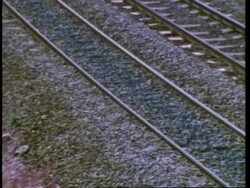 Railway track, pan left to pink rosebay willow herb, England, UK Stock Footage