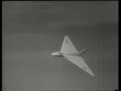 B/W delta-winged military jet flying / AVRO "Vulcan" bomber / England / SOUND Stock Footage