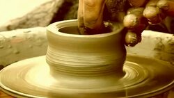 man creates pottery on a potter's wheel Stock Footage