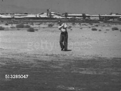 1952: LAS VEGAS, NEVADA: GOLFING: WS Male golfer hitting golf ball out of sand trap down frame, walking down & out of frame.   Upscale, upper class, luxury, leisure, sport, relaxing. Instructional Video