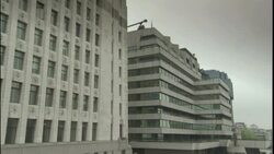 A ferry on Thames River sails past office buildings near Tower Bridge in London, England. Stock Footage