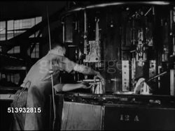 1944: ARTILLERY SHELL PRODUCTION:  MS Male worker taking out molten metal casting from blast furnace in steel mill. VS Factory making cannon shells in assembly line, molten iron, stacking completed ammunition shells from shelves. World War II, WWII Instructional Video