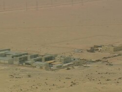 WS AERIAL ZI TS Shot of construction site with electricity towers in desert / Qatar Stock Footage