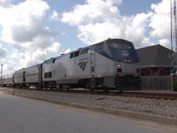 Amtrak Passenger Train Passing Through Station News Clip