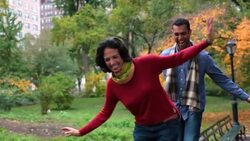New York couple in love walk across park-bench in Central Park, trying to stay balanced Stock Footage