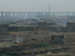 WS View of lodges in wood like rubbish dump or camp, bridge and woman dropping out trashes / Lagos, Nigeria Stock Footage