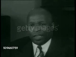 1938: DIVINE IN HARLEM: Painting of Father Divine w/ Capitol Building BG. PRESS CONFERENCE: Father Divine in home office talking to reporters SOT saying he never accepts money from individuals, is 'free gift to the world, gratis to mankind' Instructional Video