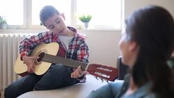 Boy playing guitar Stock Footage