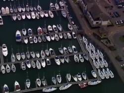 Aerial small boats/ zoom out boats in marina/ Portsmouth, England Stock Footage