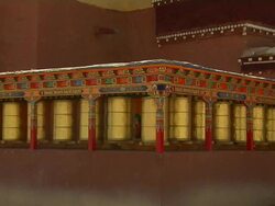 Block shot of Buddhist Prayer Wheels in motion Taklakot Tibet China Stock Footage