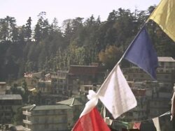 WS R/F View of flags with writing in front of local buildings / Dharamsala, Himachal Pradesh, India Stock Footage